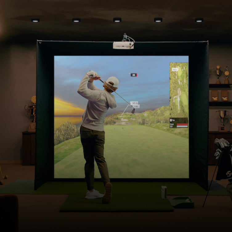Man playing golf simulator in his home on SKYTRAK plus launch monitor and software