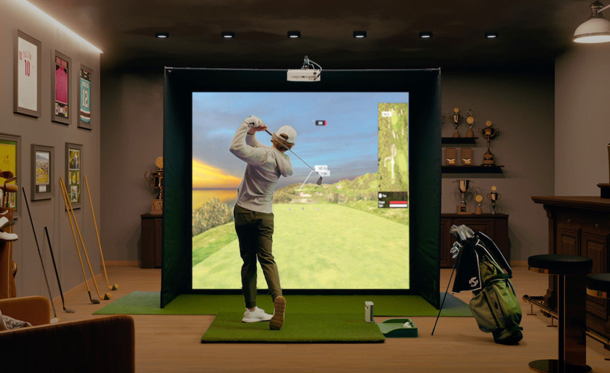 Guy playing golf on in-home golf simulator with SKYTRAK plus