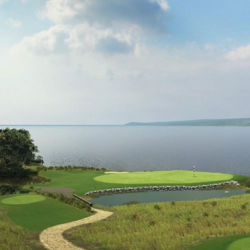 Bay Harbor Links course with a green and water feature, overlooking a body of water under a blue sky.