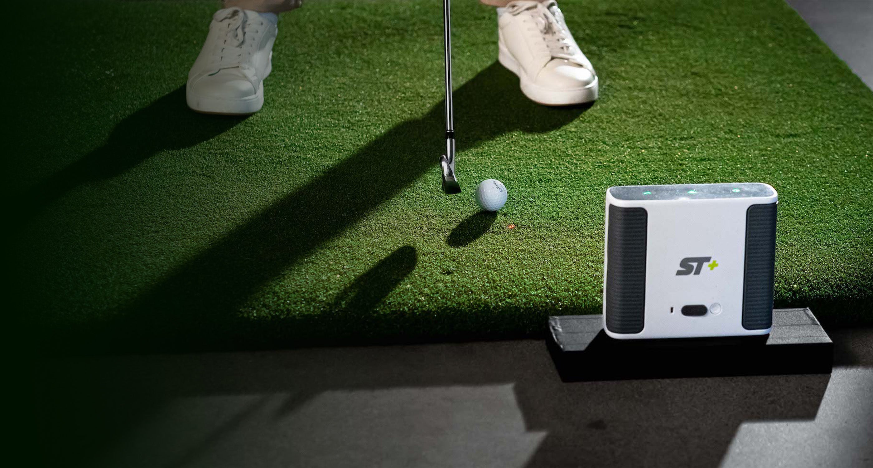 Hitting a shot on the SKYTRAK plus launch monitor off the 5 by 5 hitting mat golf sim accessory
