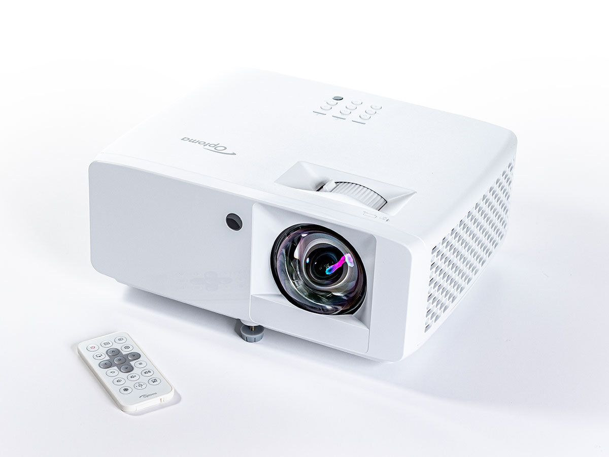 White projector with remote control on a white background