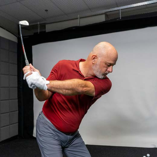 Man in GOLFTEC working on his swing