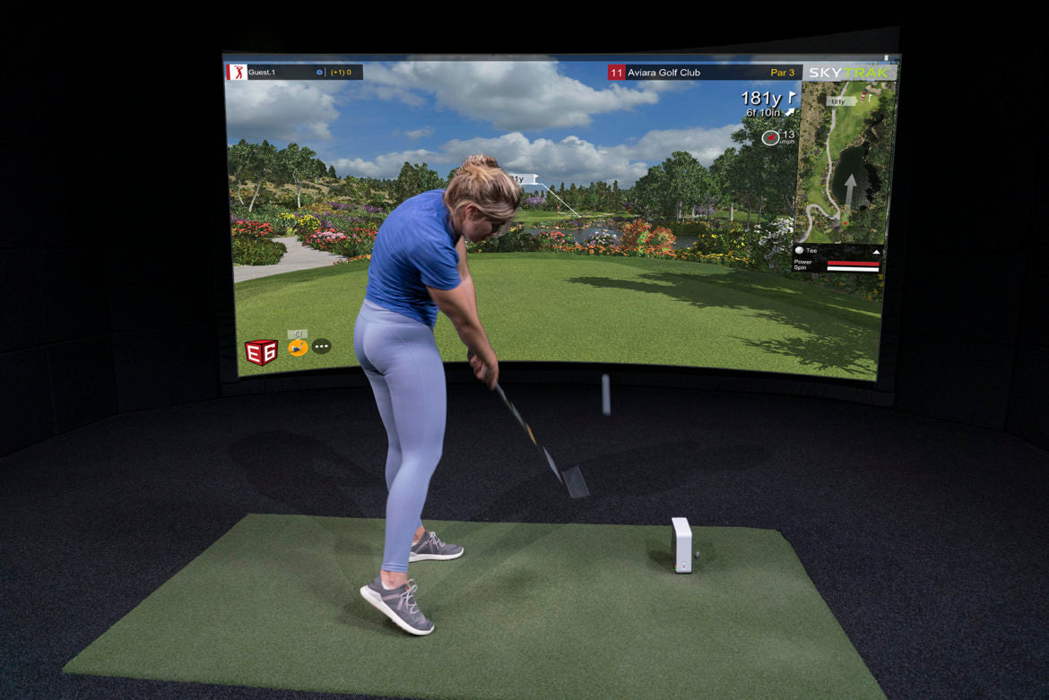 Woman practicing her swing with the most popular consumer launch monitor ever sold