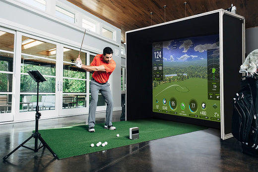 Man hitting off golf mat using a SKYTRAK and indoor sim studio