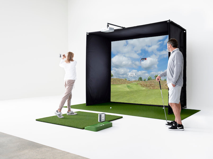 Couple playing on the SKYTRAK+ Golf Simulator Studio