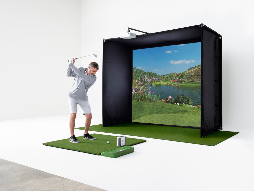 Man playing golf on his SkyTrak+ Golf Simulator Studio with his SkyTrak+ launch monitor