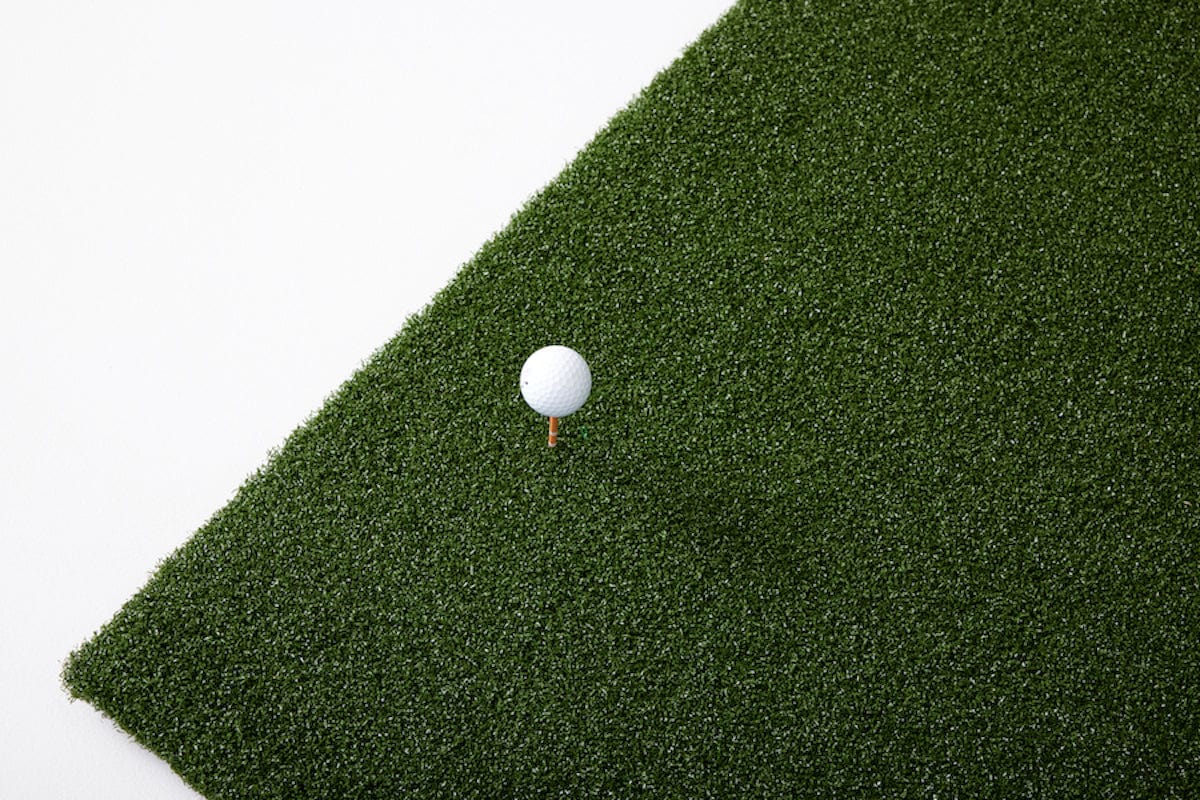 Golf ball teed up on 5 by 5 hitting mat SkyTrak golf simulation accessories