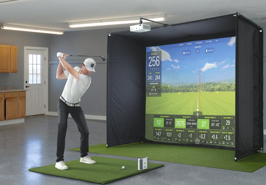 Man hitting on the SkyTrak+ Golf Simulator Studio Pro with the SkyTrak+ launch monitor