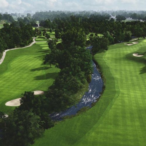 Donalda club with green grass, trees, and a stream running through it.