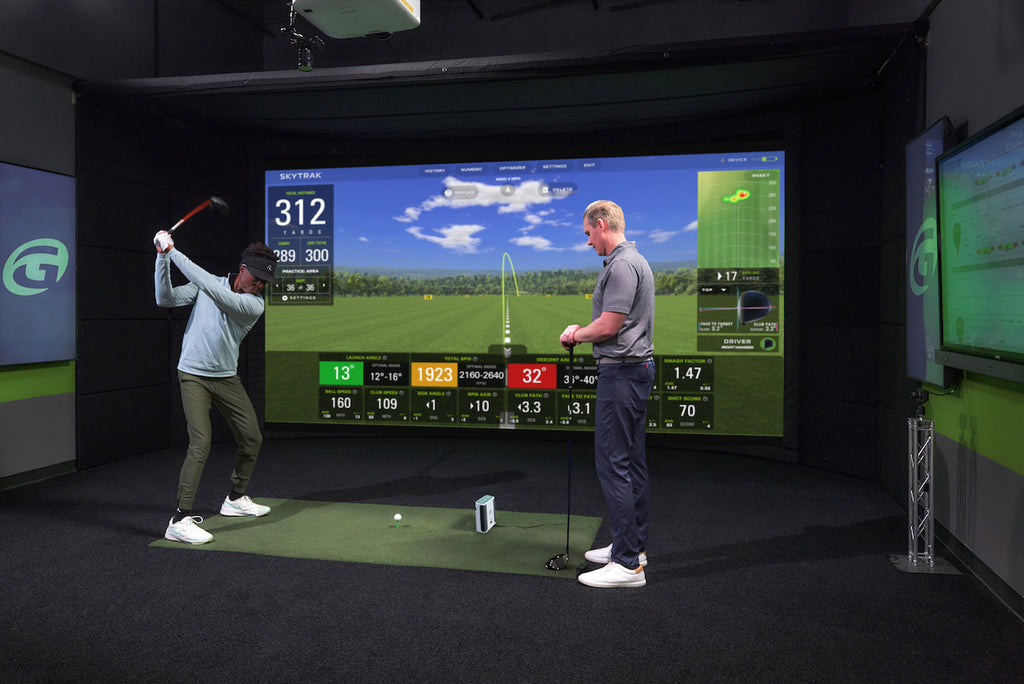 Man in GOLFTEC getting a lesson on the SkyTrak Plus launch monitor