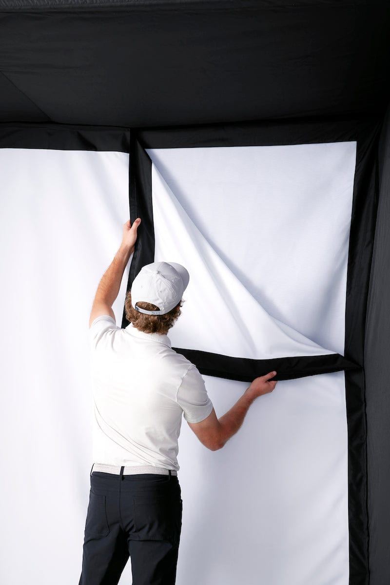 Man installing high impact screen for the SkyTrak Studio enclosure