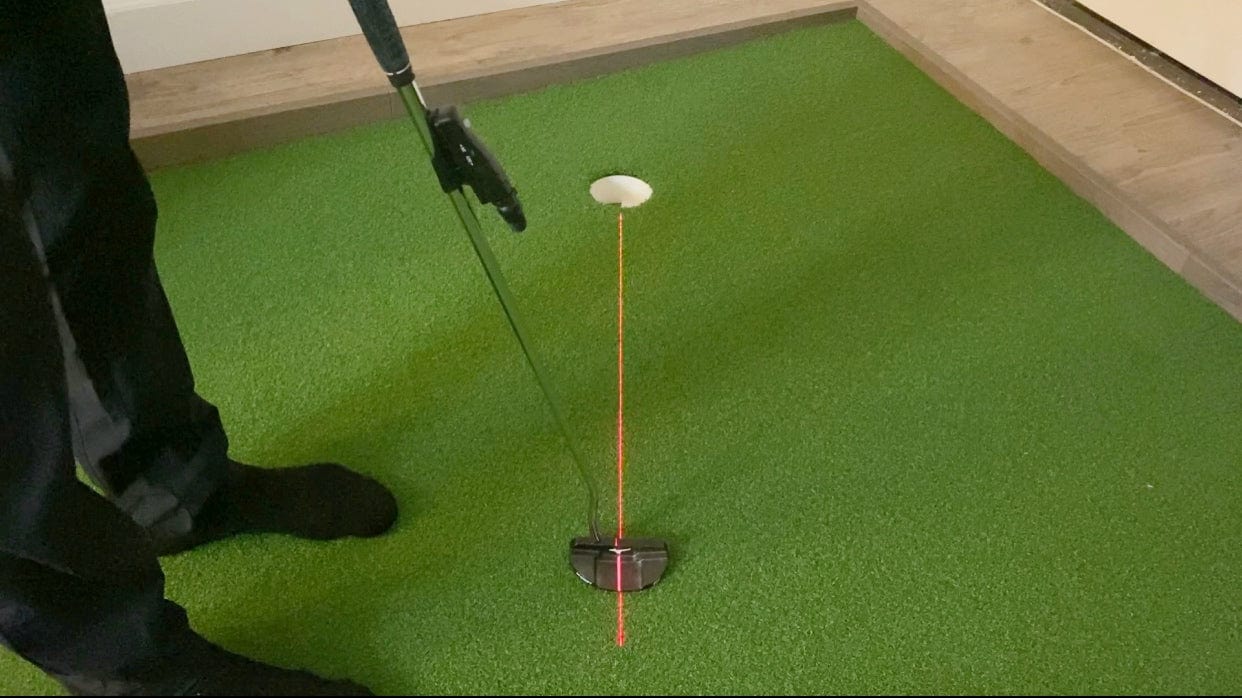 Putting Laser being use on an indoor putting mat