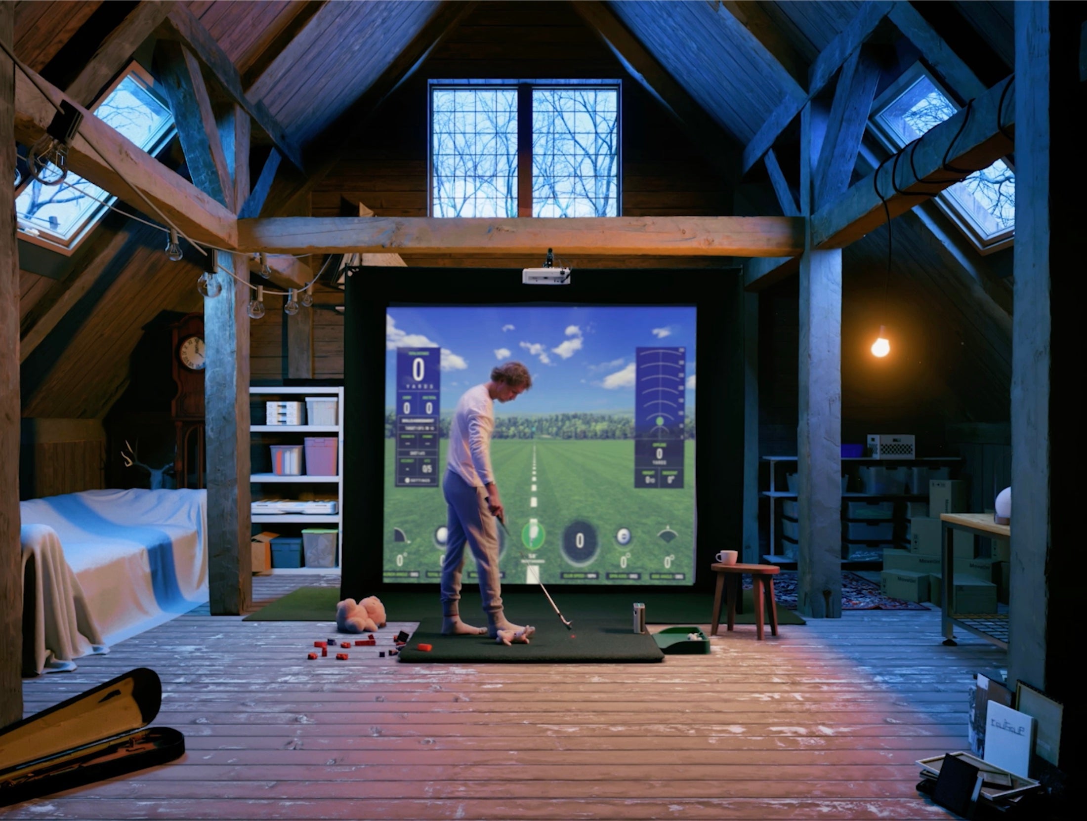 Man playing golf in attic on SKYTRAK plus golf sim